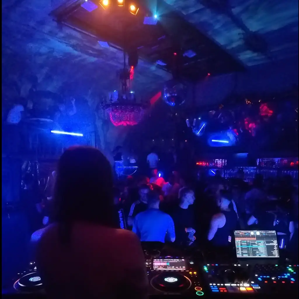 Dark warehouse party with laser beams