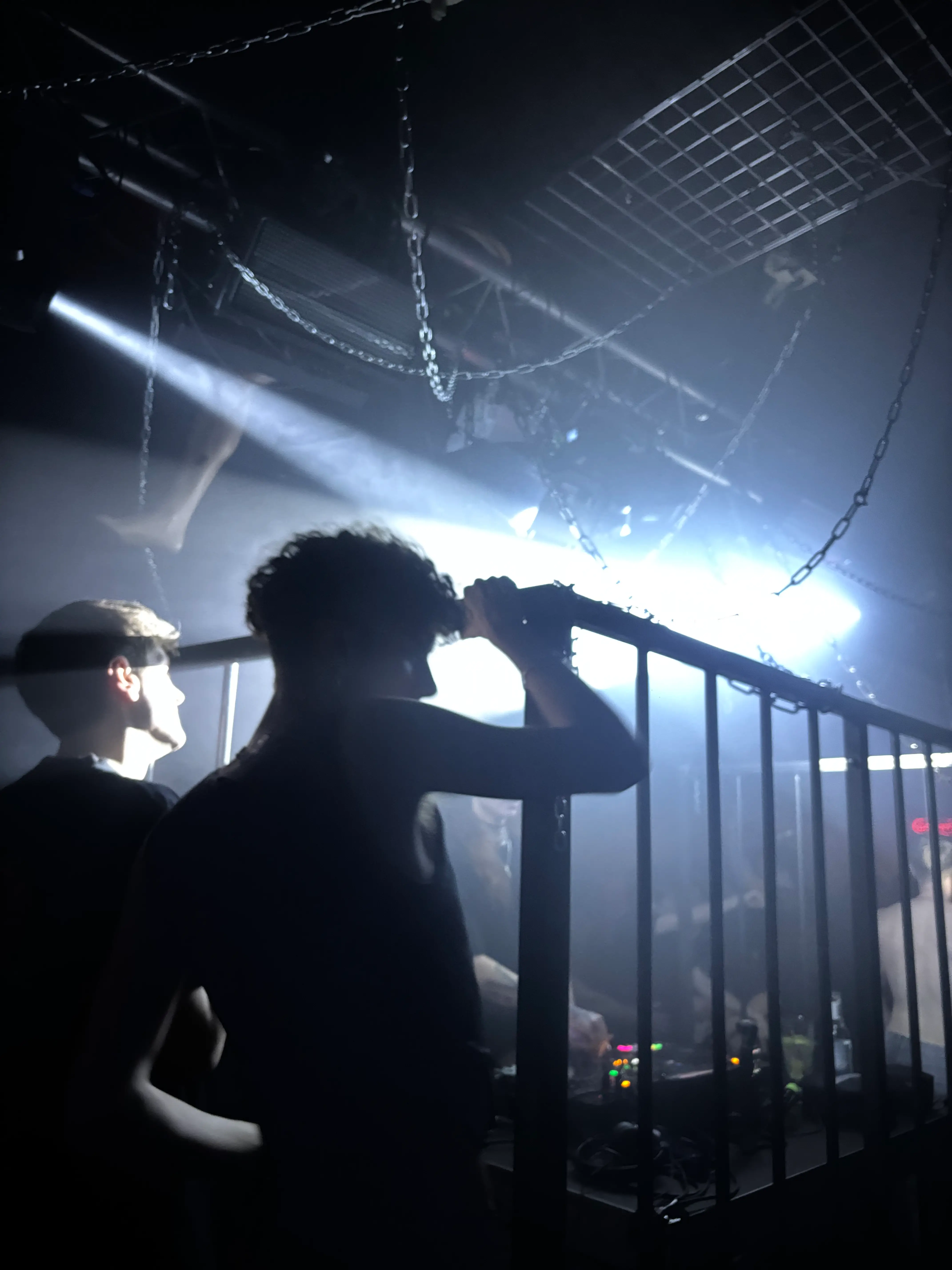 Dark warehouse party with laser beams